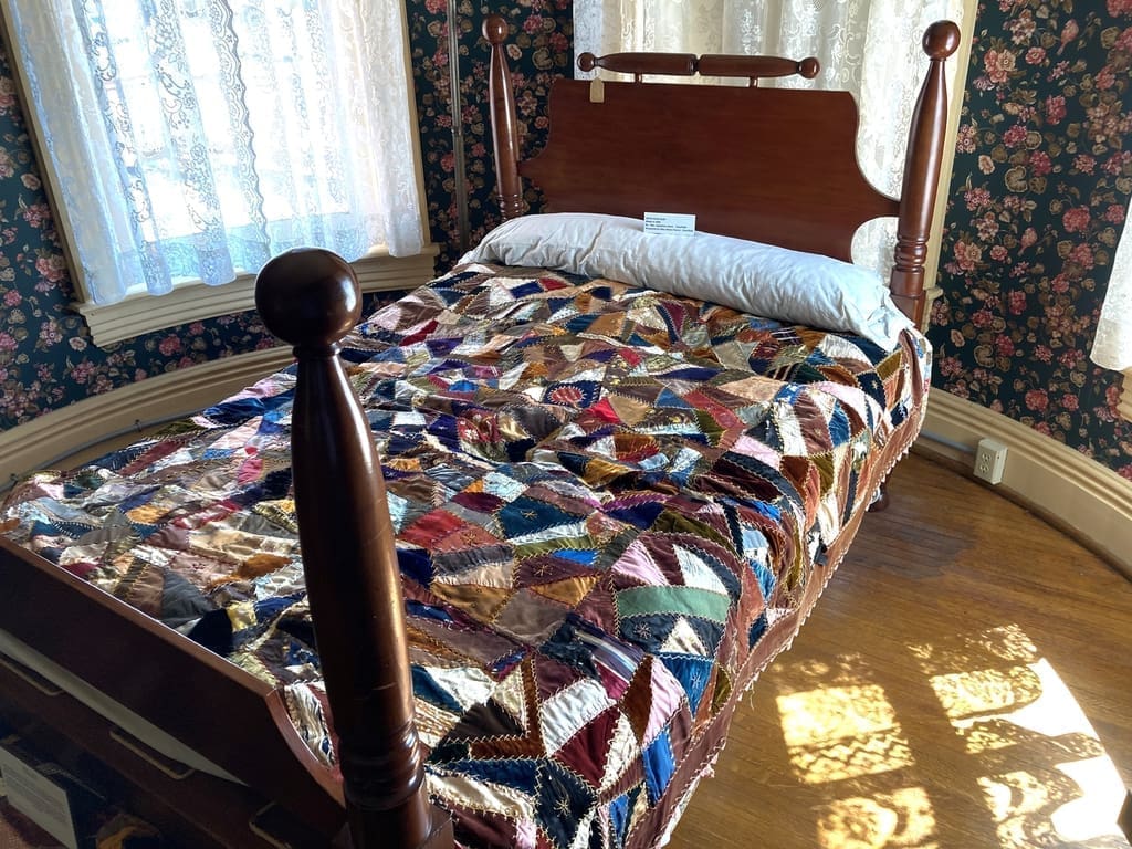 Handmade ‘hap’ or quilt type blanket on poster bed